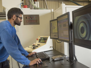 A man in front of a HMI operating a CVE electron beam welder